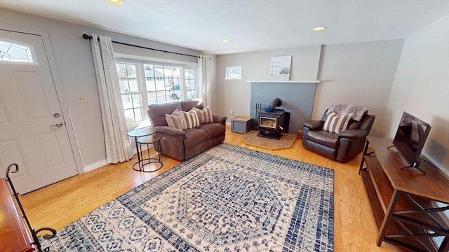 living room featuring a wood stove and hardwood / wood-style floors