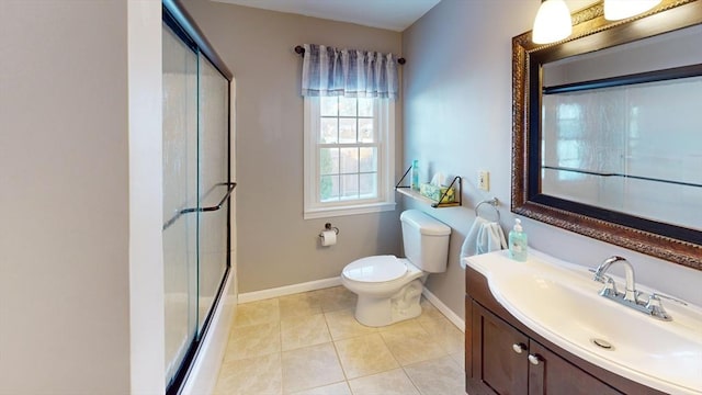 full bathroom with enclosed tub / shower combo, vanity, tile patterned floors, and toilet