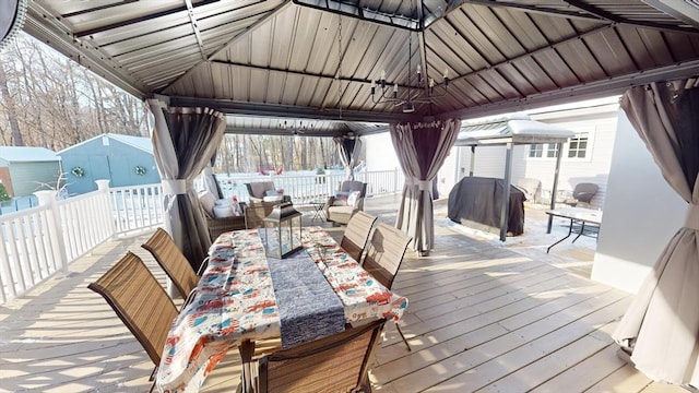 wooden terrace featuring a gazebo