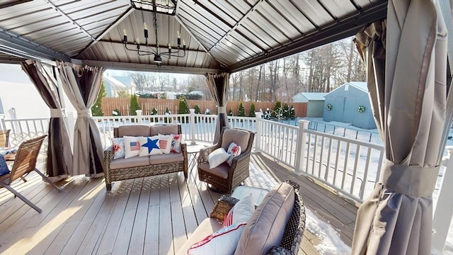 snow covered deck with a gazebo, ceiling fan, and an outdoor hangout area