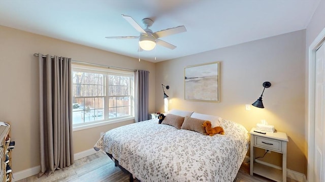 bedroom with hardwood / wood-style floors and ceiling fan