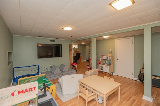 living room with wood finished floors and visible vents