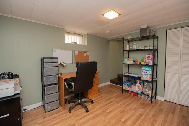 home office featuring baseboards, ornamental molding, and light wood-type flooring
