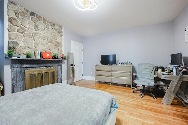 bedroom with baseboards and wood finished floors