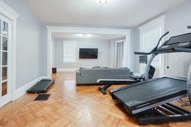 exercise room featuring visible vents, baseboards, and plenty of natural light