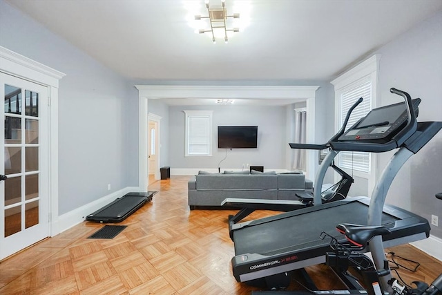 exercise room featuring visible vents, baseboards, and plenty of natural light