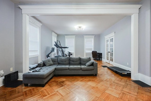 living area featuring visible vents, french doors, and baseboards