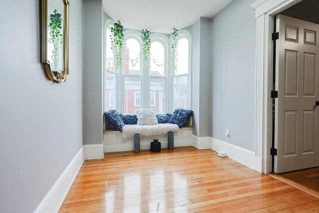 unfurnished room featuring baseboards and light wood-style floors