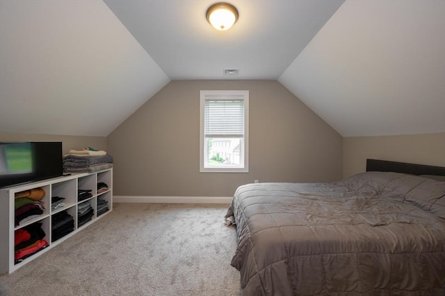 bedroom featuring carpet floors and lofted ceiling