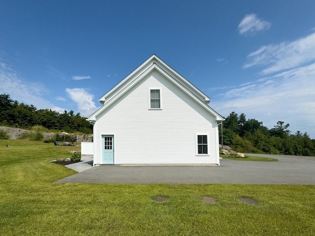 view of property exterior featuring a lawn