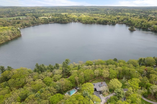 view of property location with a forest and a large body of water