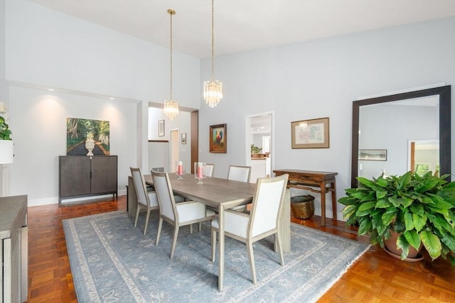 dining area with a chandelier and a high ceiling