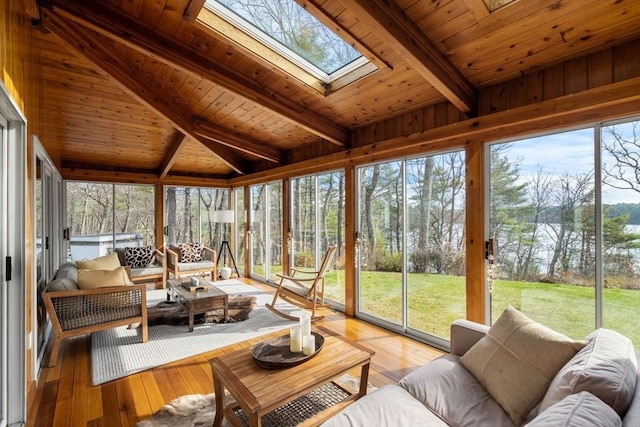 sunroom / solarium with an outdoor living space, beamed ceiling, a skylight, and healthy amount of natural light