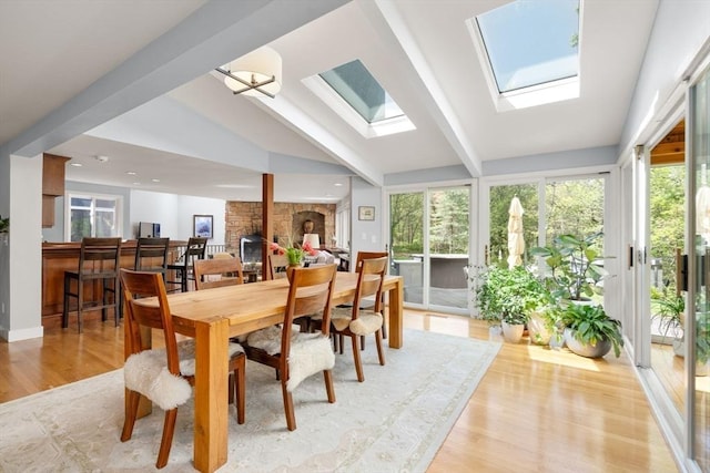 sunroom / solarium with beam ceiling and a skylight