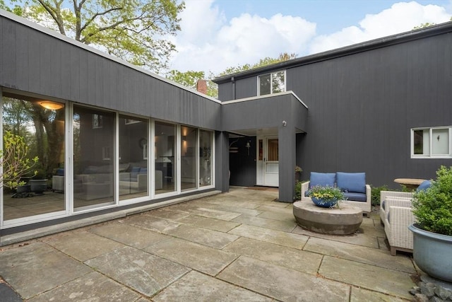 rear view of property featuring a patio and an outdoor hangout area
