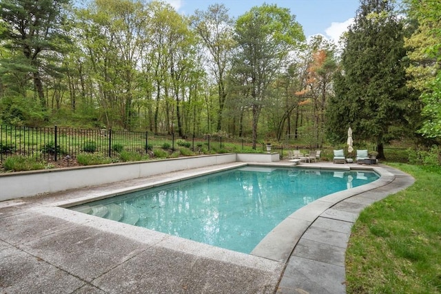 view of swimming pool featuring fence and a patio
