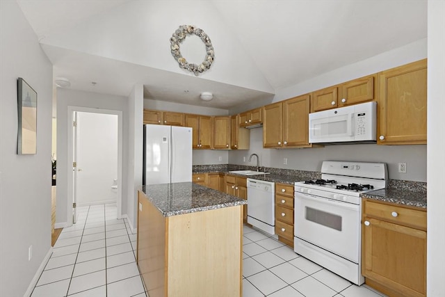 kitchen featuring lofted ceiling, white appliances, light tile patterned flooring, a sink, and a kitchen island