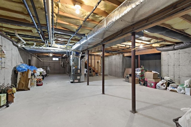 unfinished basement with stairway and heating unit