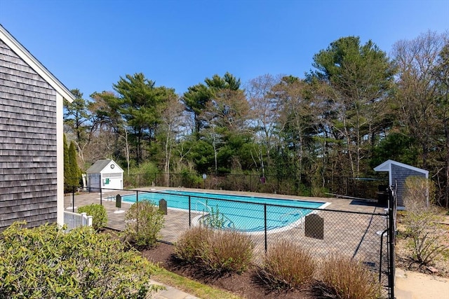 pool with a patio and fence