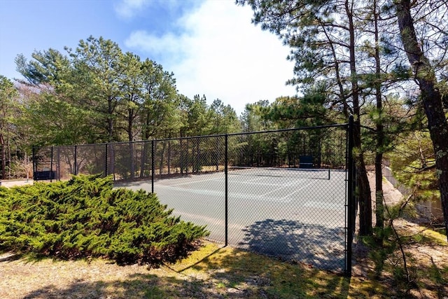 view of tennis court with fence