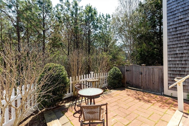 view of patio with a gate and fence