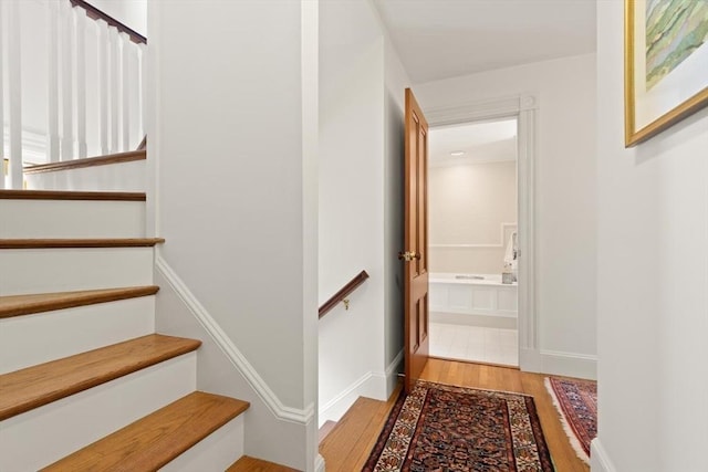210 Melrose St, Newton, MA 02466 - stairs featuring wood finished floors and baseboards