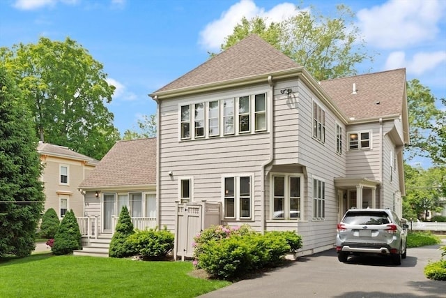 210 Melrose St, Newton, MA 02466 - back of property featuring a lawn, a shingled roof, and asphalt driveway