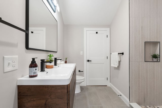 bathroom with tile patterned flooring, vanity, and toilet