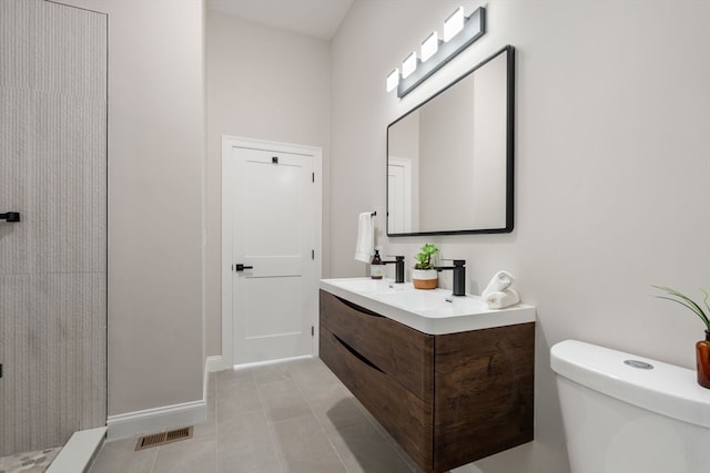 bathroom with tile patterned floors, vanity, and toilet