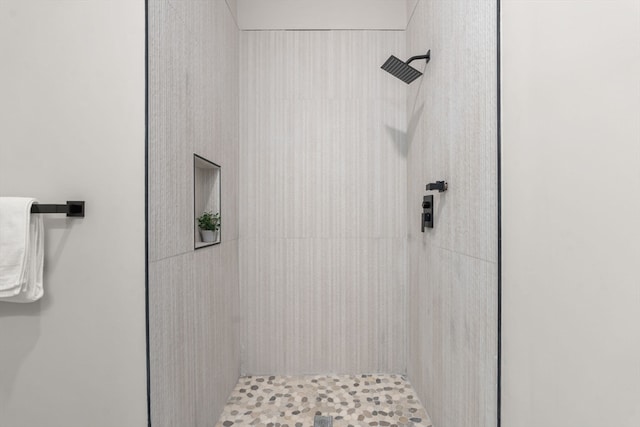 bathroom with a tile shower