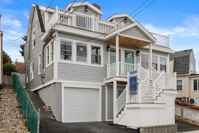 view of front facade with a balcony and a garage