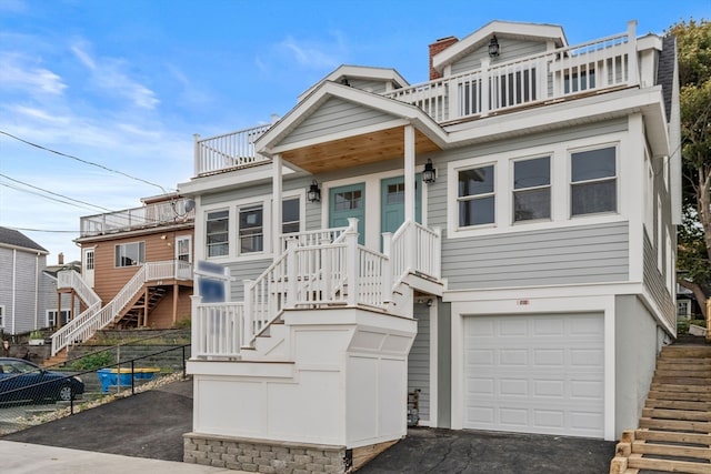 view of front of property with a balcony and a garage