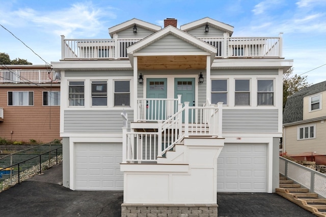 view of front facade with a balcony and a garage