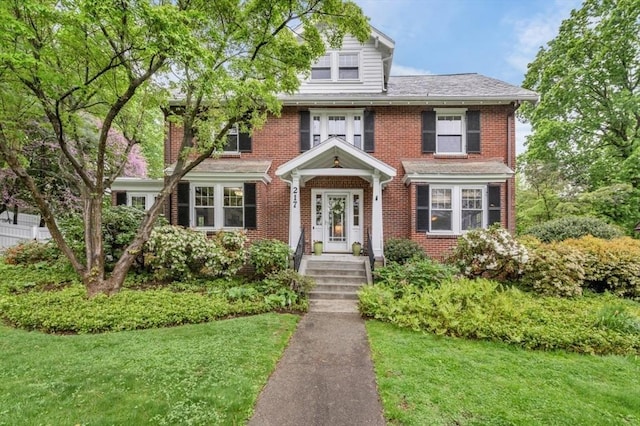 view of front of property with brick siding and a front lawn