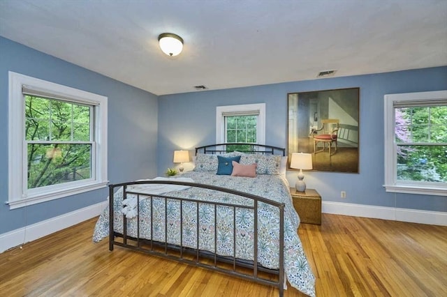 bedroom with wood finished floors and baseboards