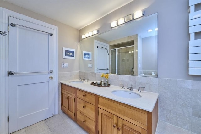 bathroom with a shower stall, tile patterned floors, and double vanity