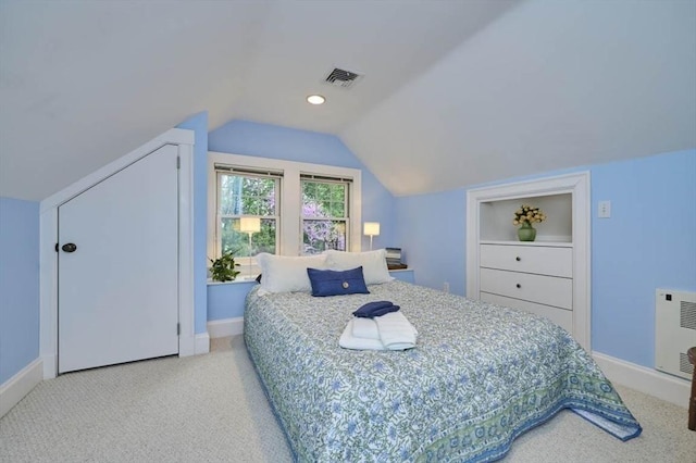 carpeted bedroom featuring baseboards and vaulted ceiling
