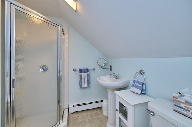 bathroom with baseboard heating, toilet, vaulted ceiling, a shower stall, and a sink