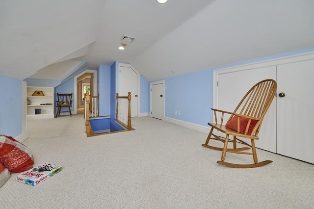 sitting room with carpet, vaulted ceiling, an upstairs landing, and baseboards