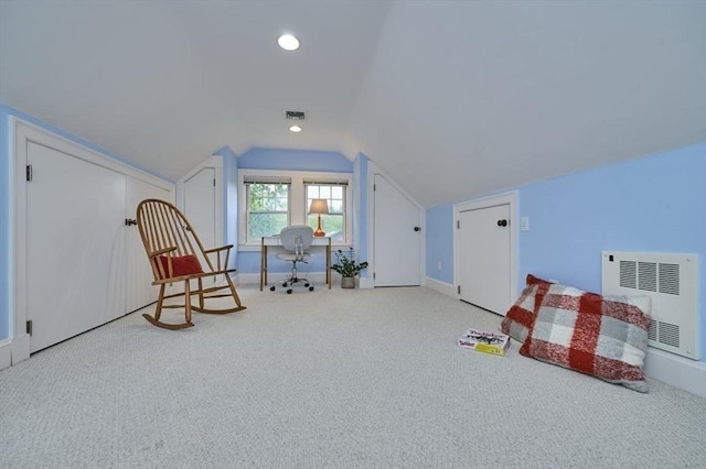 sitting room with heating unit, carpet flooring, vaulted ceiling, and baseboards