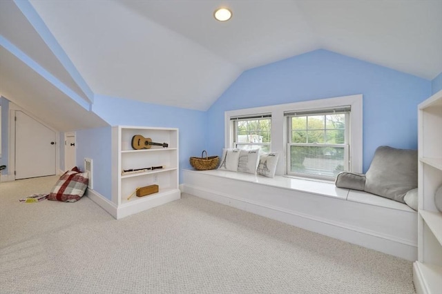 rec room featuring vaulted ceiling, carpet, and built in shelves