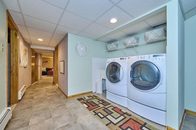 clothes washing area with a baseboard heating unit, washer and dryer, baseboards, and recessed lighting