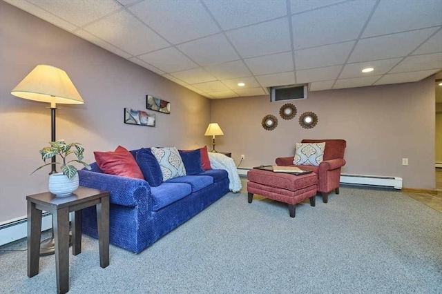 carpeted living area with a baseboard heating unit, a drop ceiling, recessed lighting, and baseboards