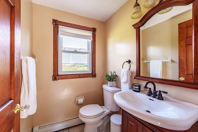 half bathroom featuring vanity, a baseboard radiator, and toilet