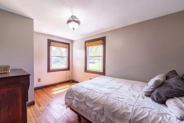 bedroom with baseboards and light wood-type flooring