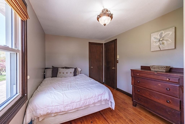 bedroom featuring a closet and light wood-style floors