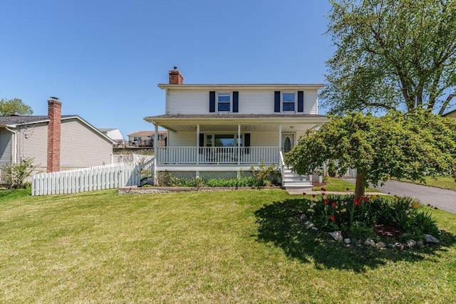 view of front of home with covered porch, fence, a chimney, and a front lawn