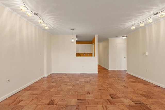 empty room featuring track lighting and light parquet floors