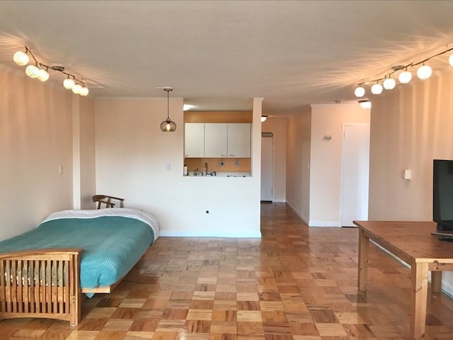 interior space with light parquet floors and rail lighting