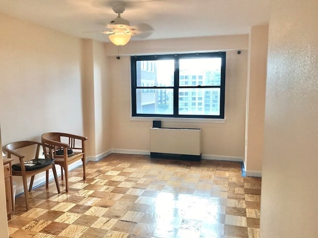 empty room with radiator heating unit and ceiling fan